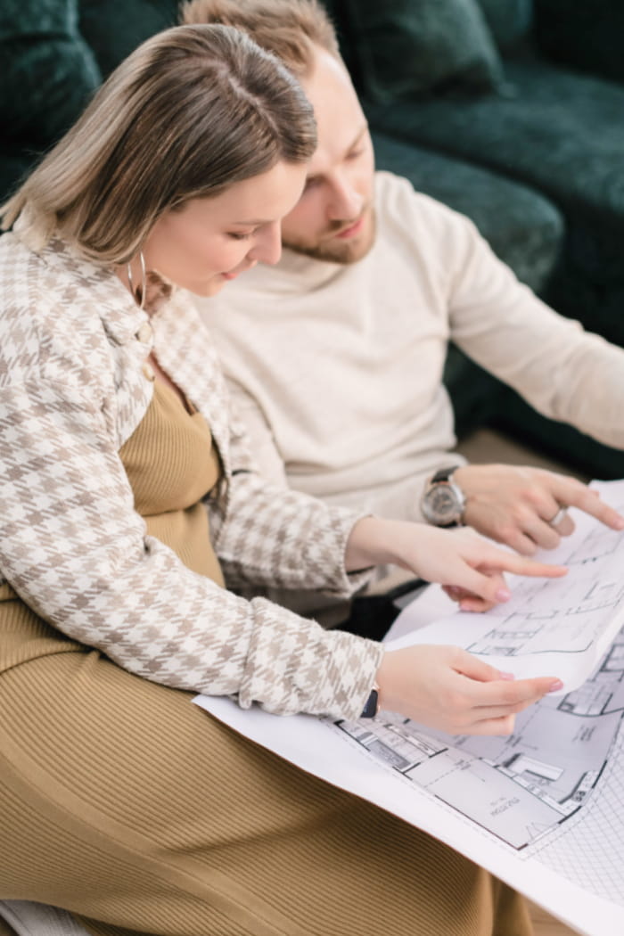 Couple examining floorplans